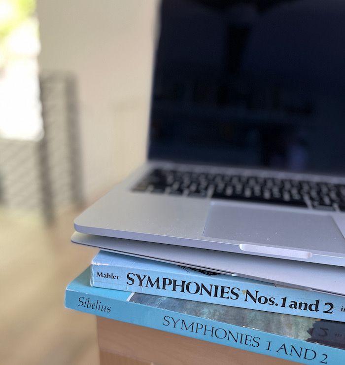 computers stacked on orchestral scores. it represents my career path.